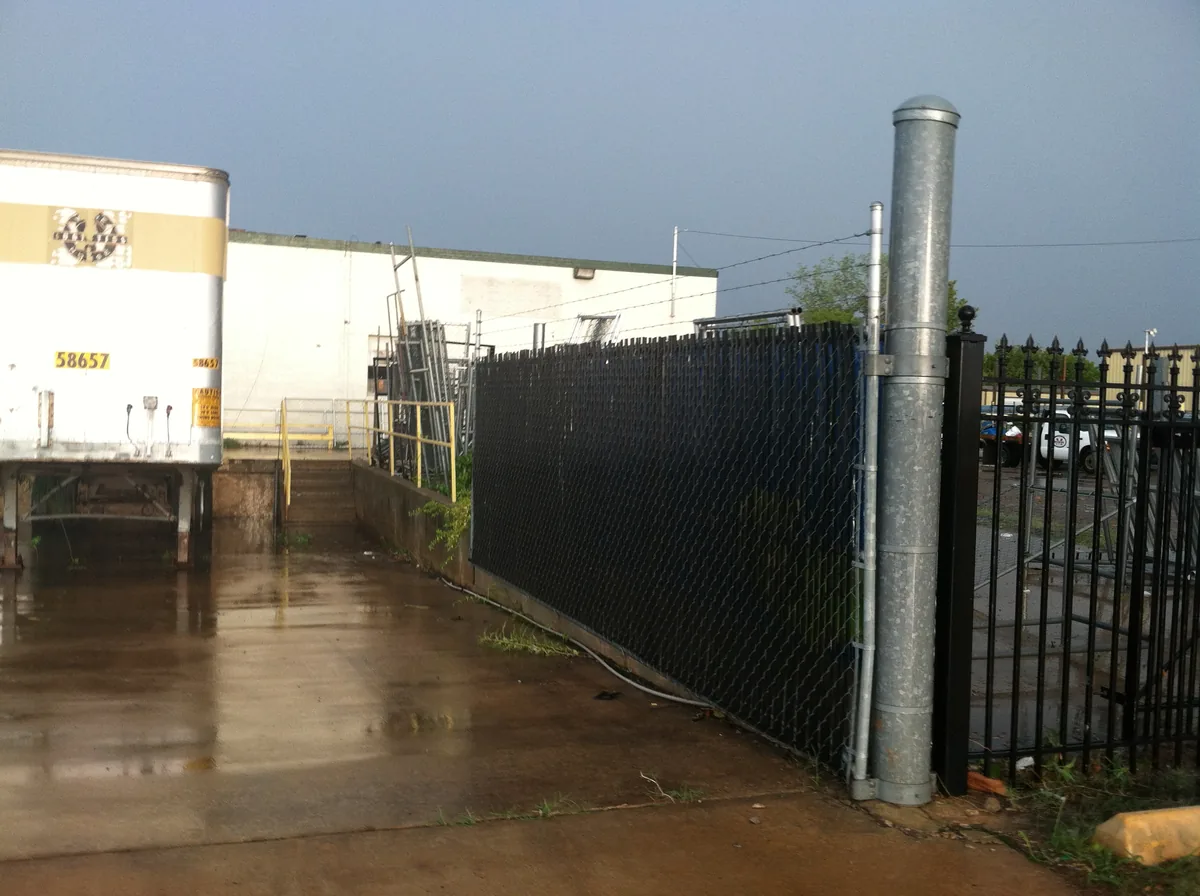 Black chain link fence around a commercial building