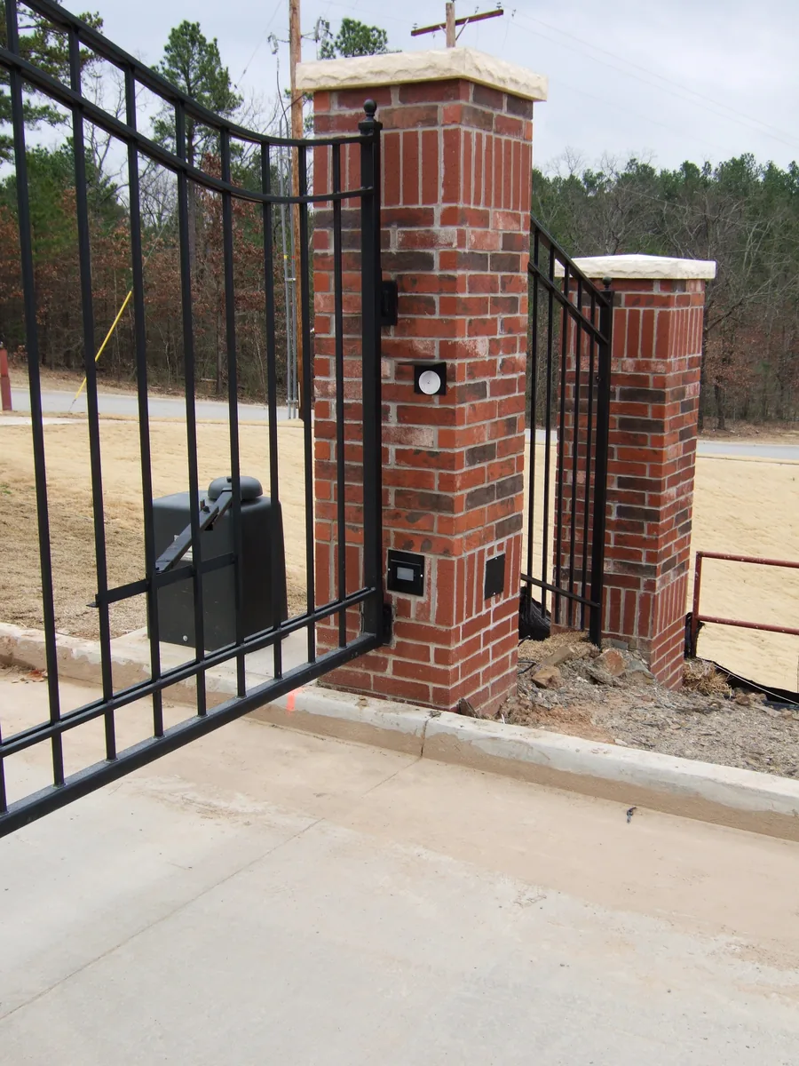 Automatic gate operator mounted on a brick column