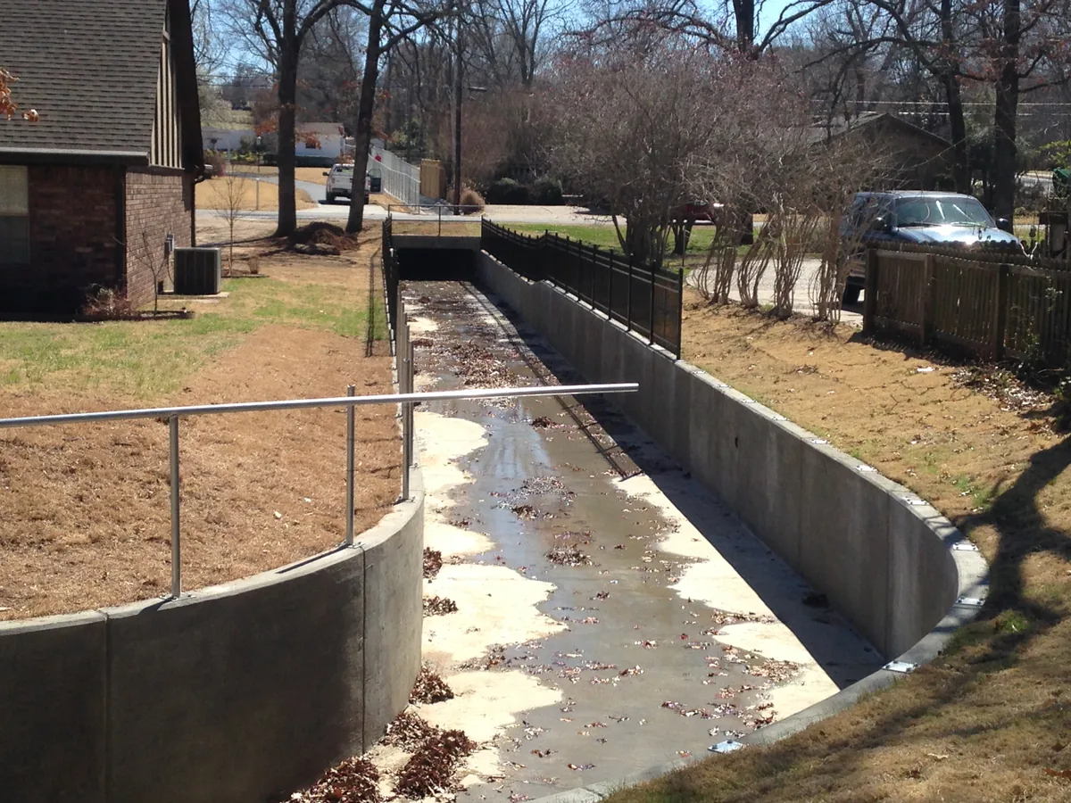Pipe rail barrier running along a drainage channel