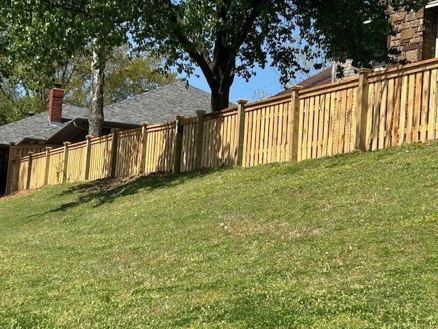 Wood privacy fence stepped down a sloped residential boundary