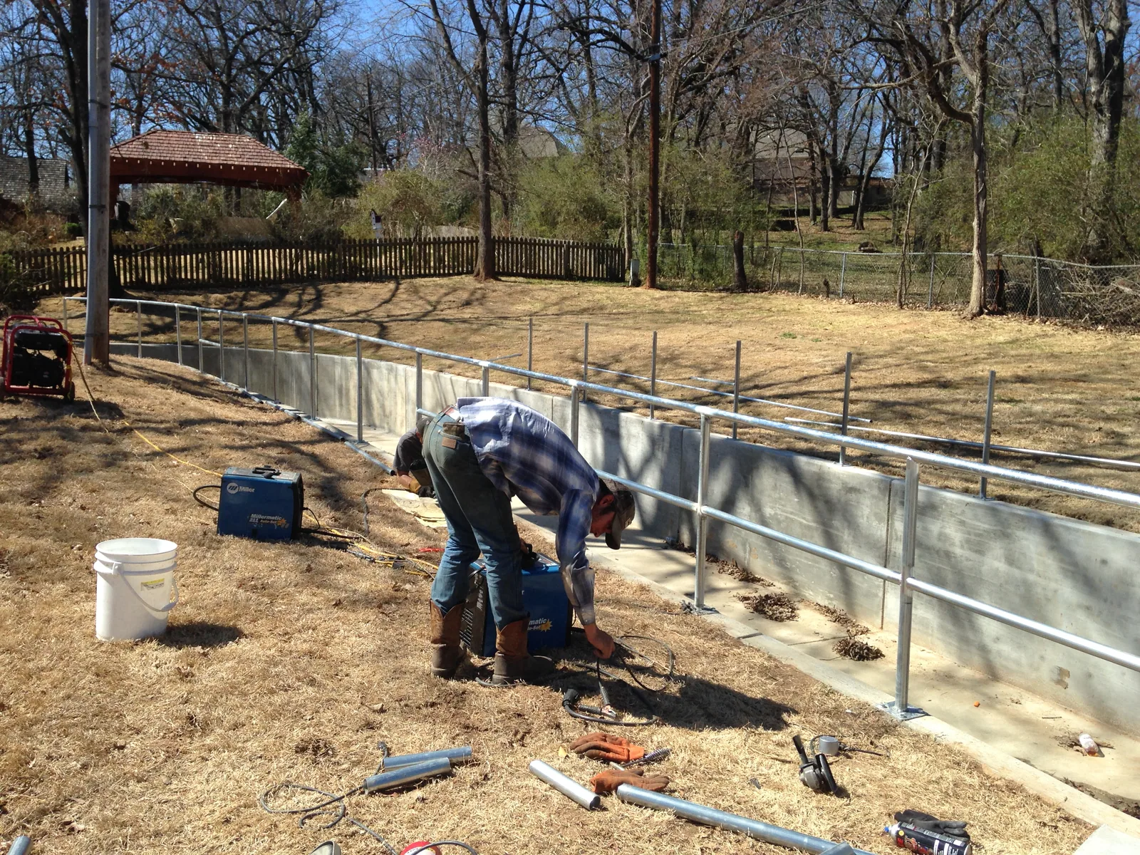 Industrial guardrail and handrail system installed on a concrete structure