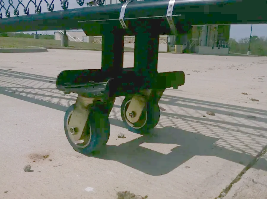 Roller assembly under a sliding gate